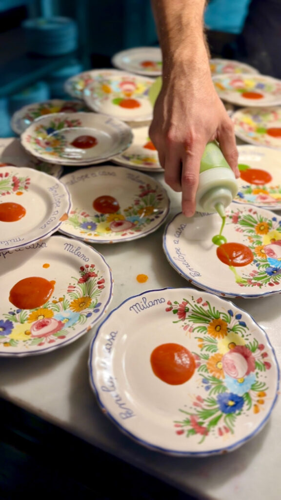 Plating food at Penelope a Casa in Milan