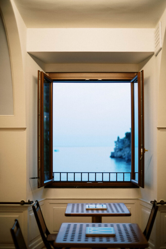Ocean view fromm the window above a dining table at L'Antica Cartiera restaurant at Hotel Marmorata.
