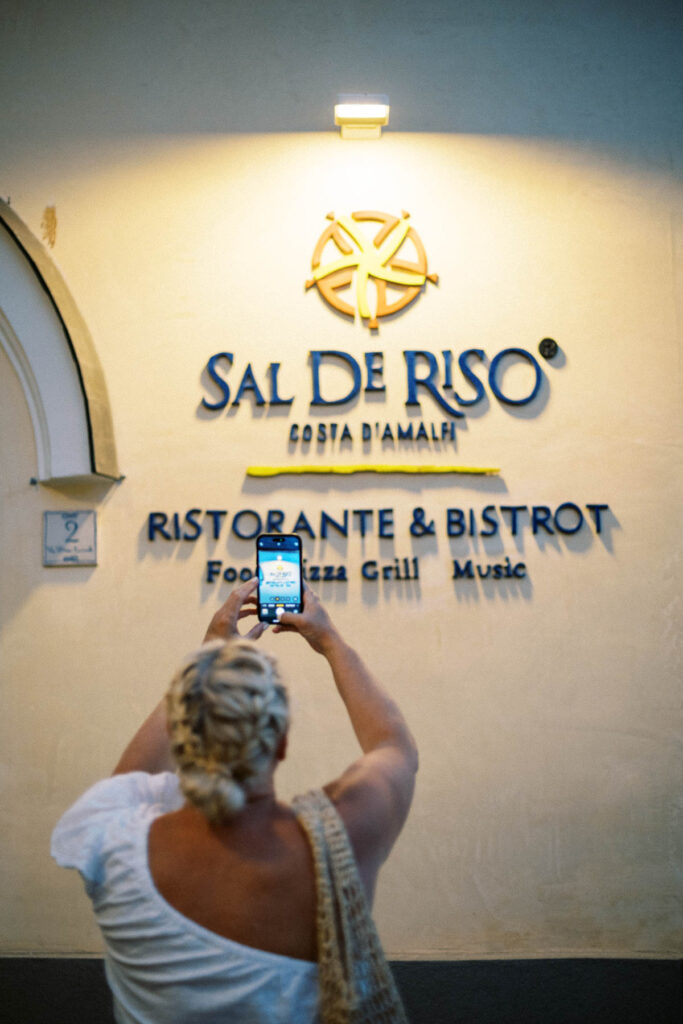 Sal De Riso Costa D'Amalfi restaurant with traveler taking a photo of the restaurant.