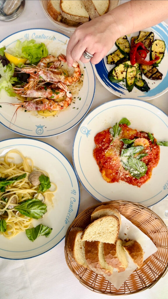 An overhead view of authentic Amalfi Coast pasta and seafood dishes.