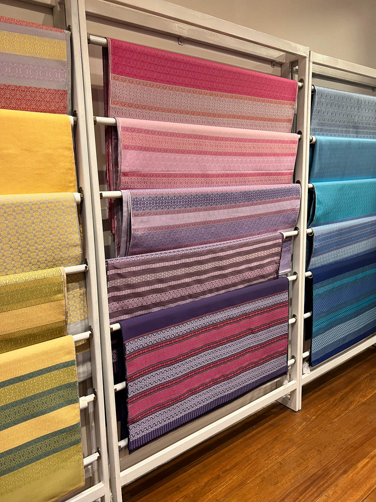 Shelves of colorful folded fabric in Thailand