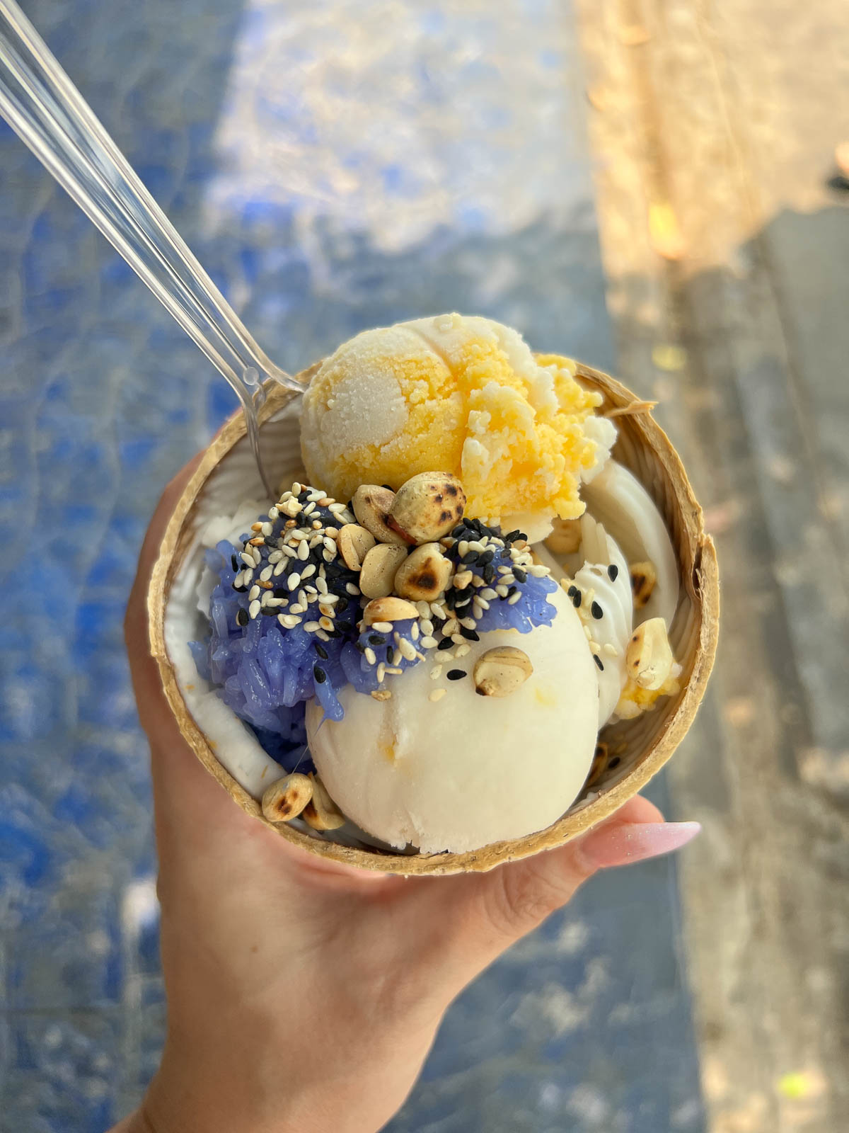 A coconut shell filled with ice cream and toppings in Thailand
