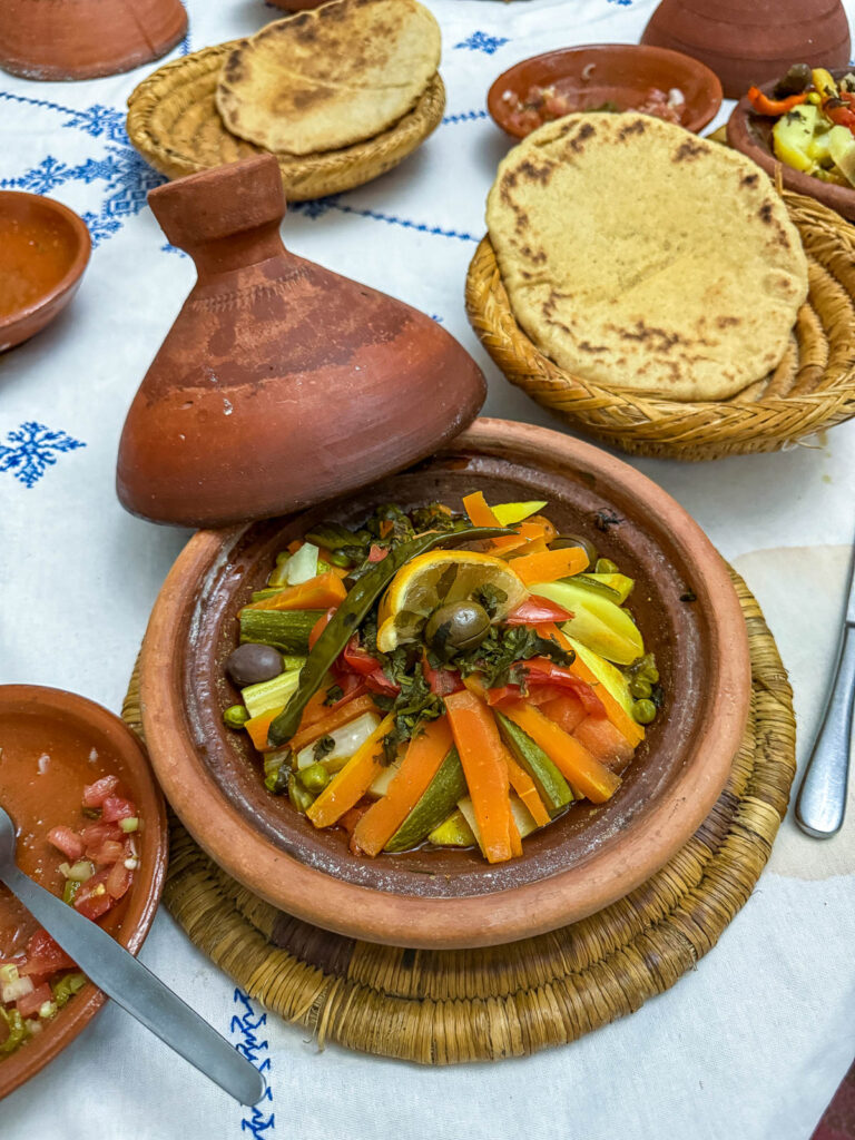 Tagine filled with cooked meat and vegetables.