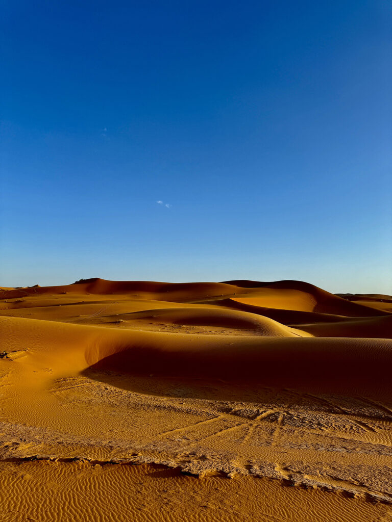 Sand dunes with bright blue sky.