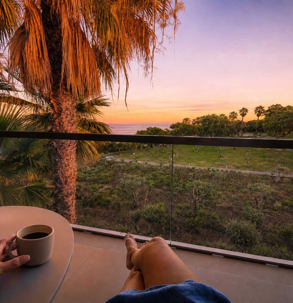 View from our hotel balcony at sunset with a palm tree at Kimpton Atlântico Algarve