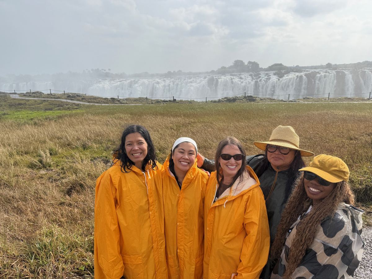 Five women in rain ponchos at Victoria Falls on our Southern Africa trip