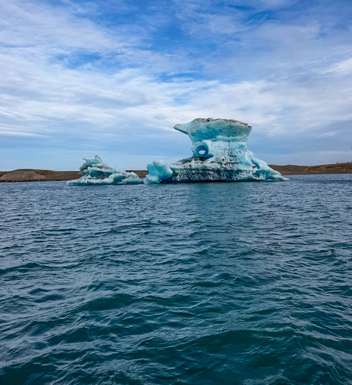 A blue iceberg floating in Jökulsárlón Glacier Lagoon