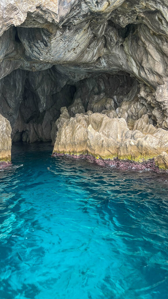A sea cave with glowing turquoise water at Capri.