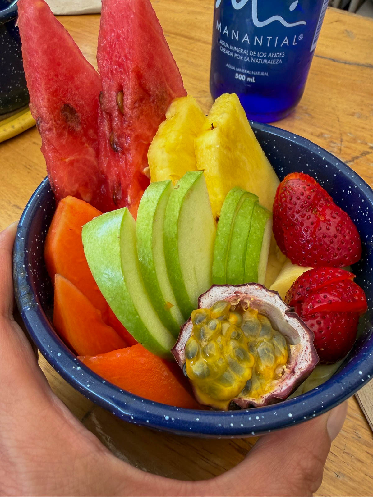 Cup of fresh fruit with watermelon, pineapple, mango, strawberries, and passion fruit