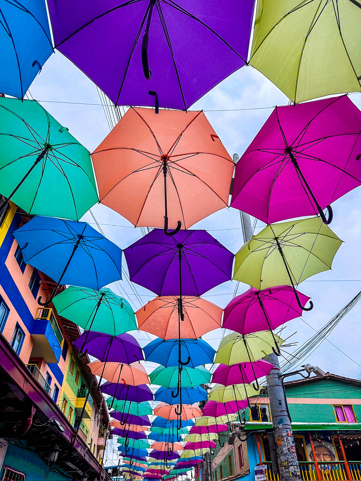 Colorful umbrellas hanging over a street in Guatapé