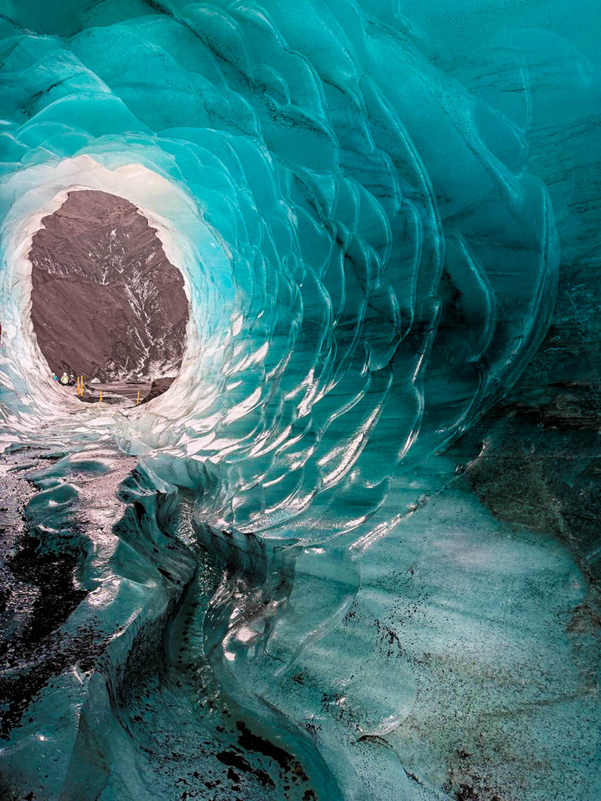 Looking through the rippled blue ice of Katla Ice Cave toward the opening