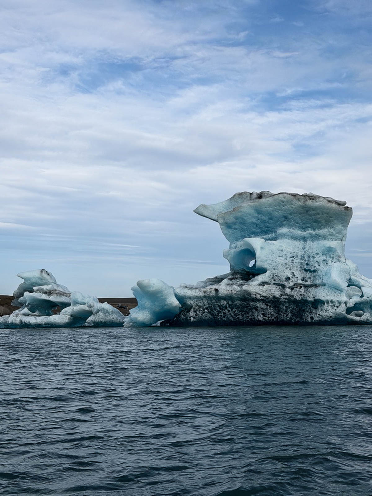 Blue icebergs floating in Jökulsárlón Glacier Lagoon, seen from the boat