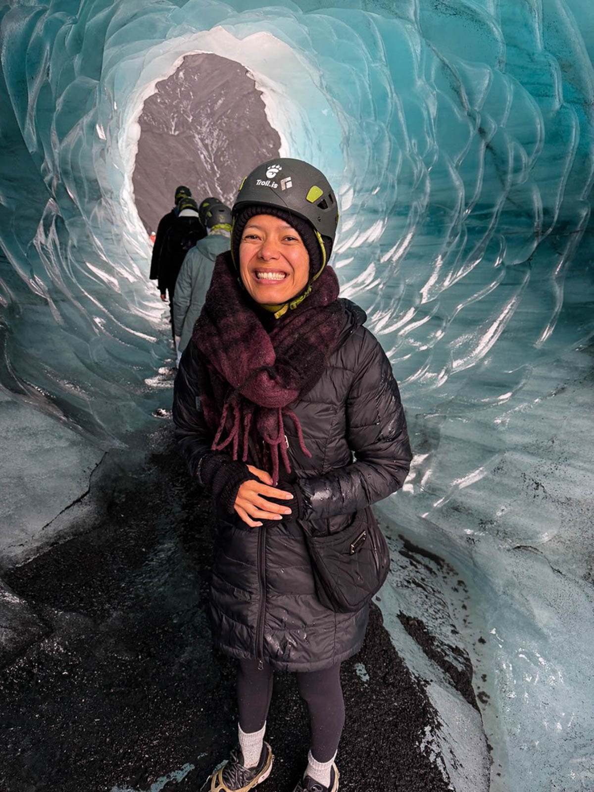 Toni standing inside the blue ice tunnel of Katla Ice Cave in Iceland