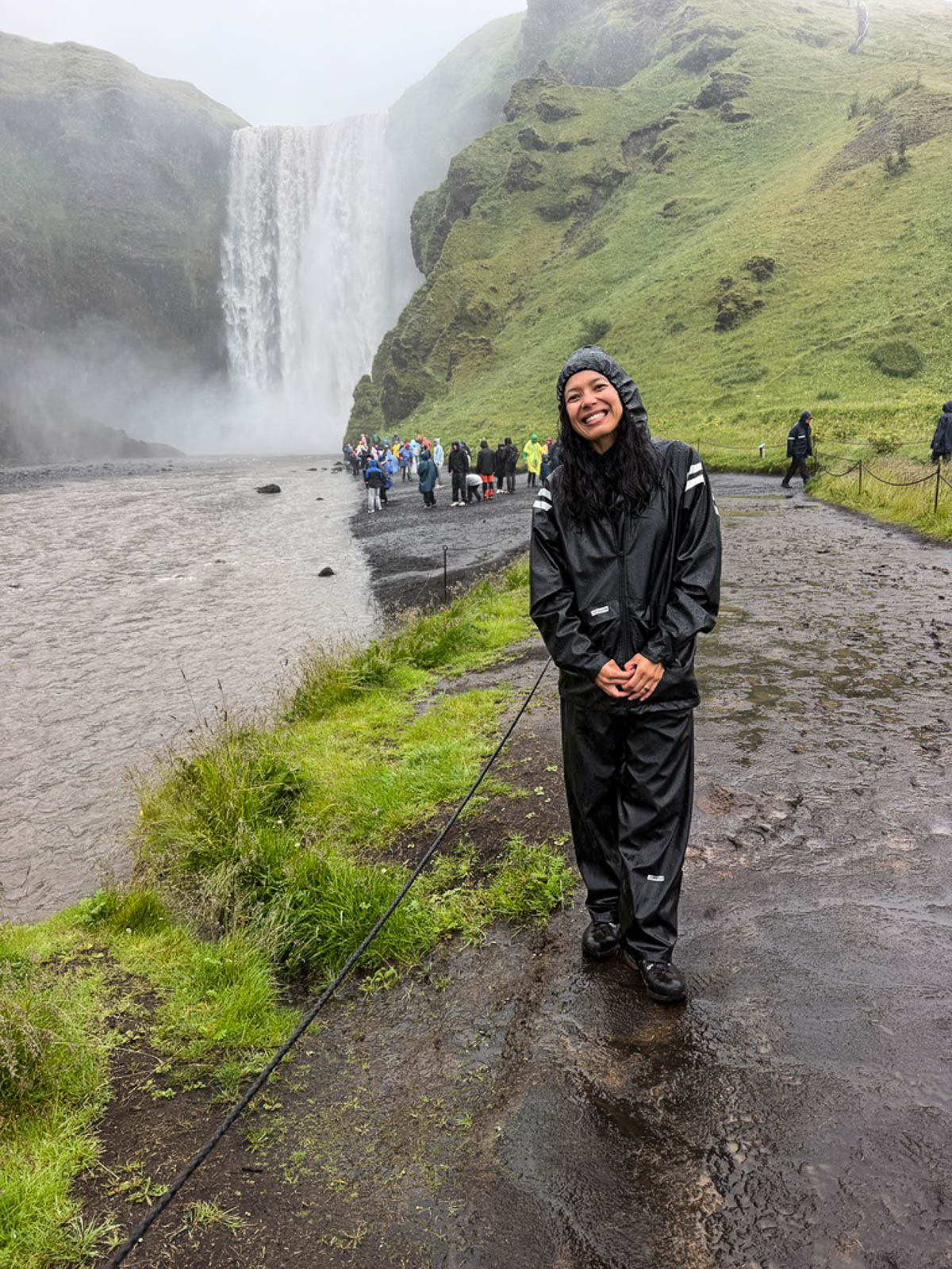 Toni standing on the path in front of Skógafoss waterfall in Iceland