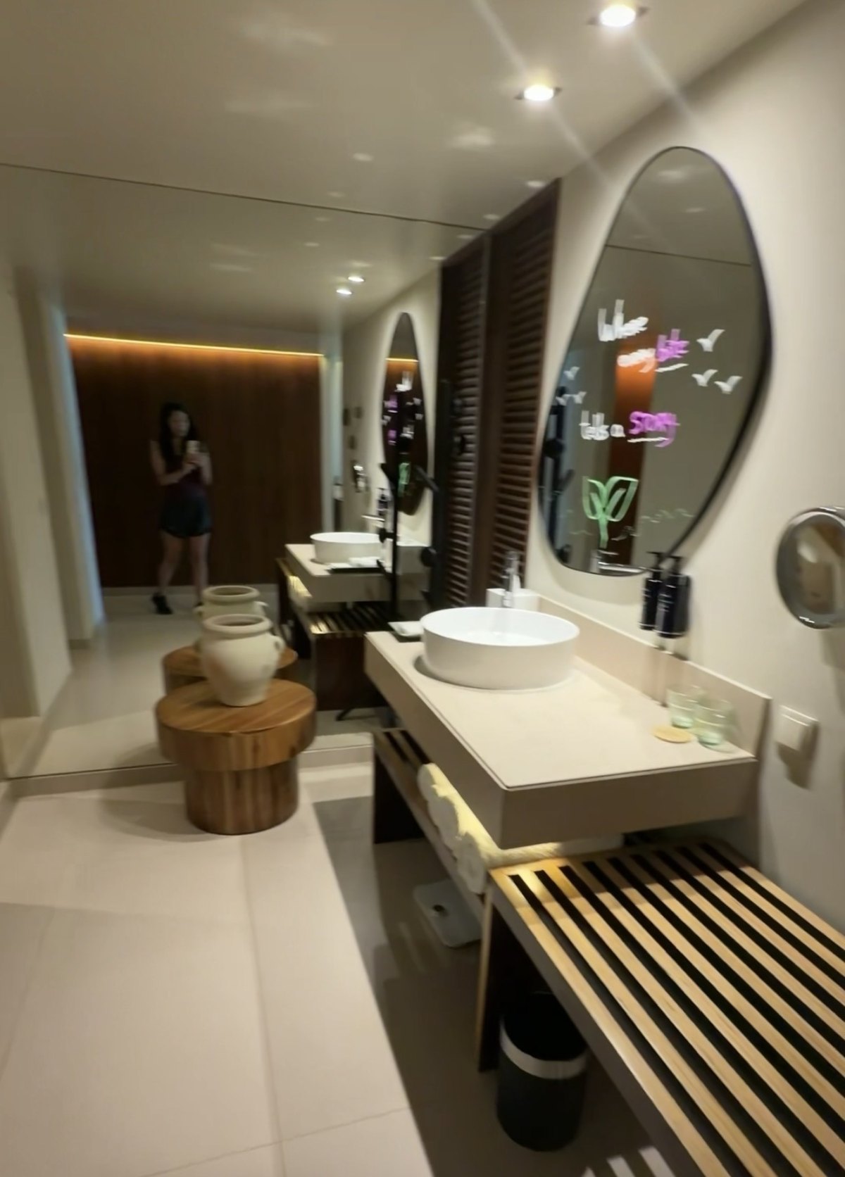 Bathroom with a round sink and mirror in our room at Kimpton Atlântico Algarve