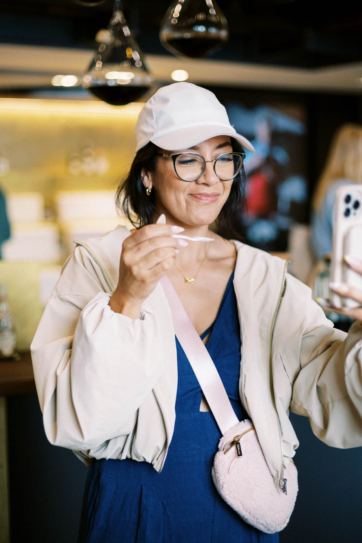 A traveler tasting aged balsamic vinegar from a small spoon on the Milan food tour