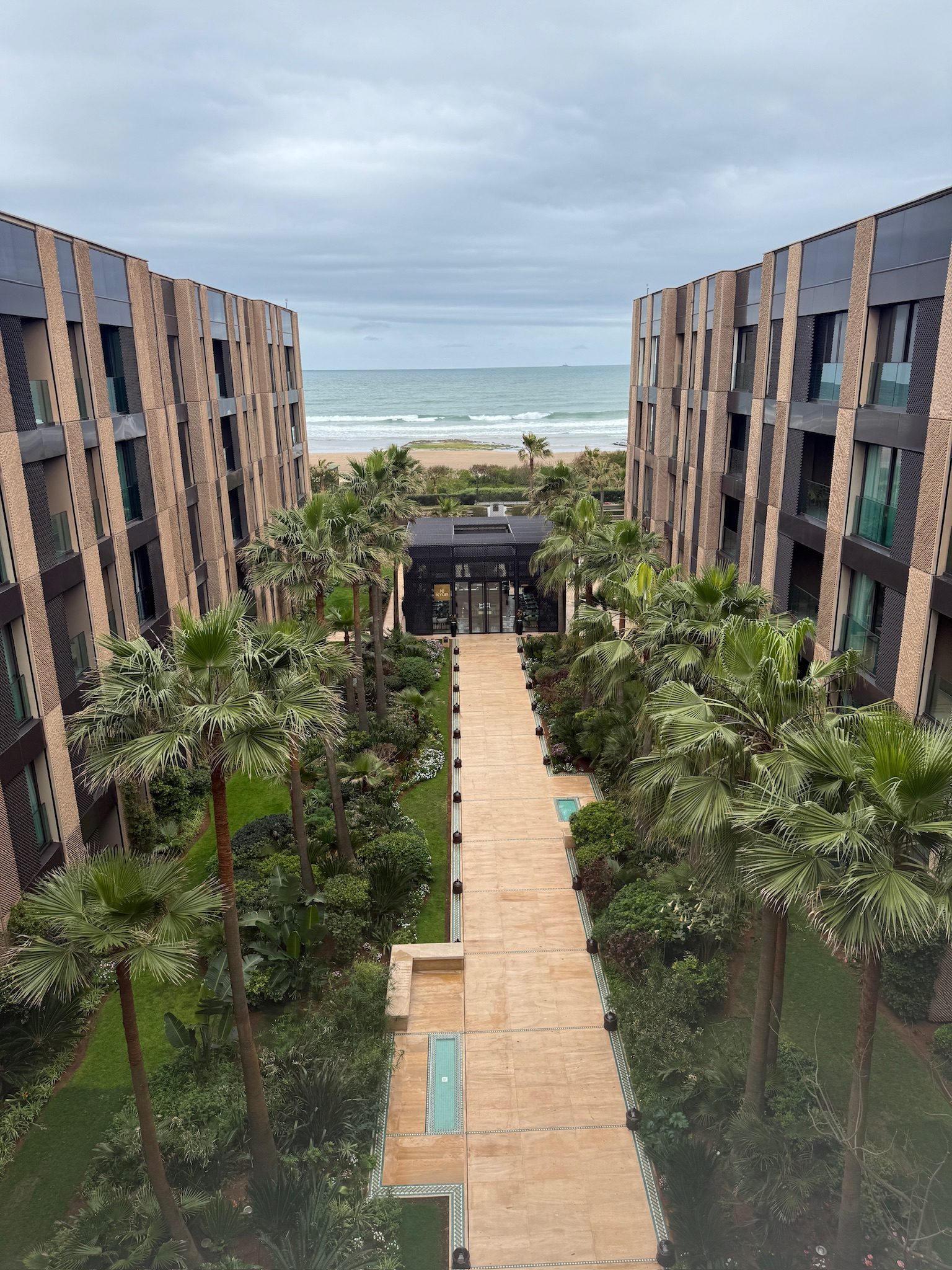 Palm-lined garden path at the Four Seasons Casablanca leading out to the ocean