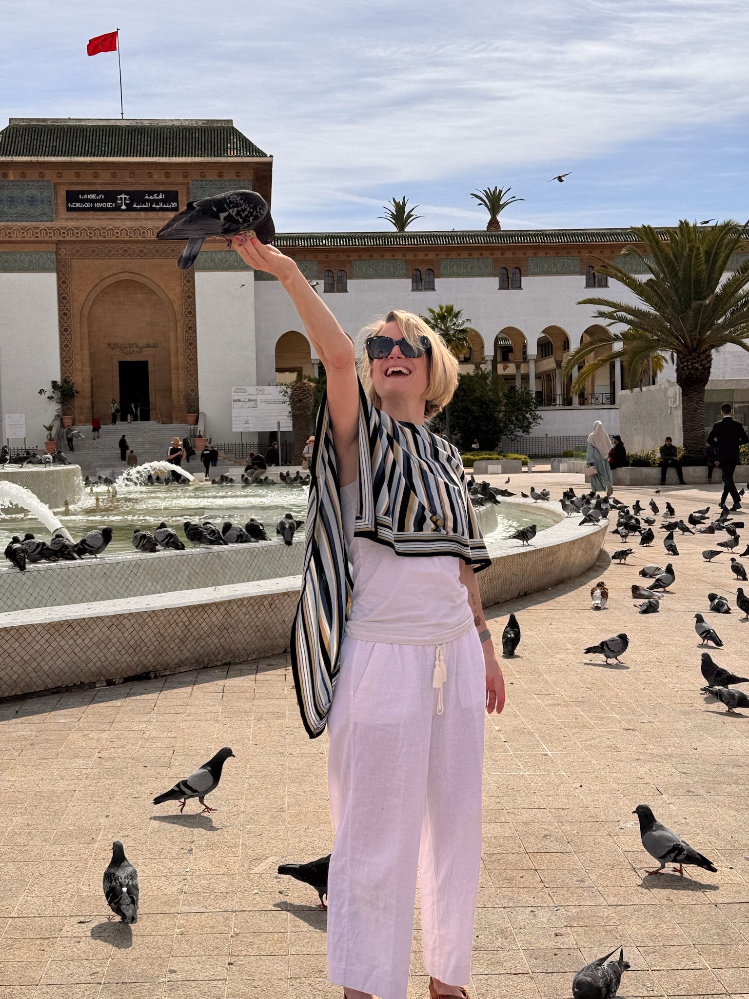 Woman feeding pigeons in Mohammed V Square, Casablanca