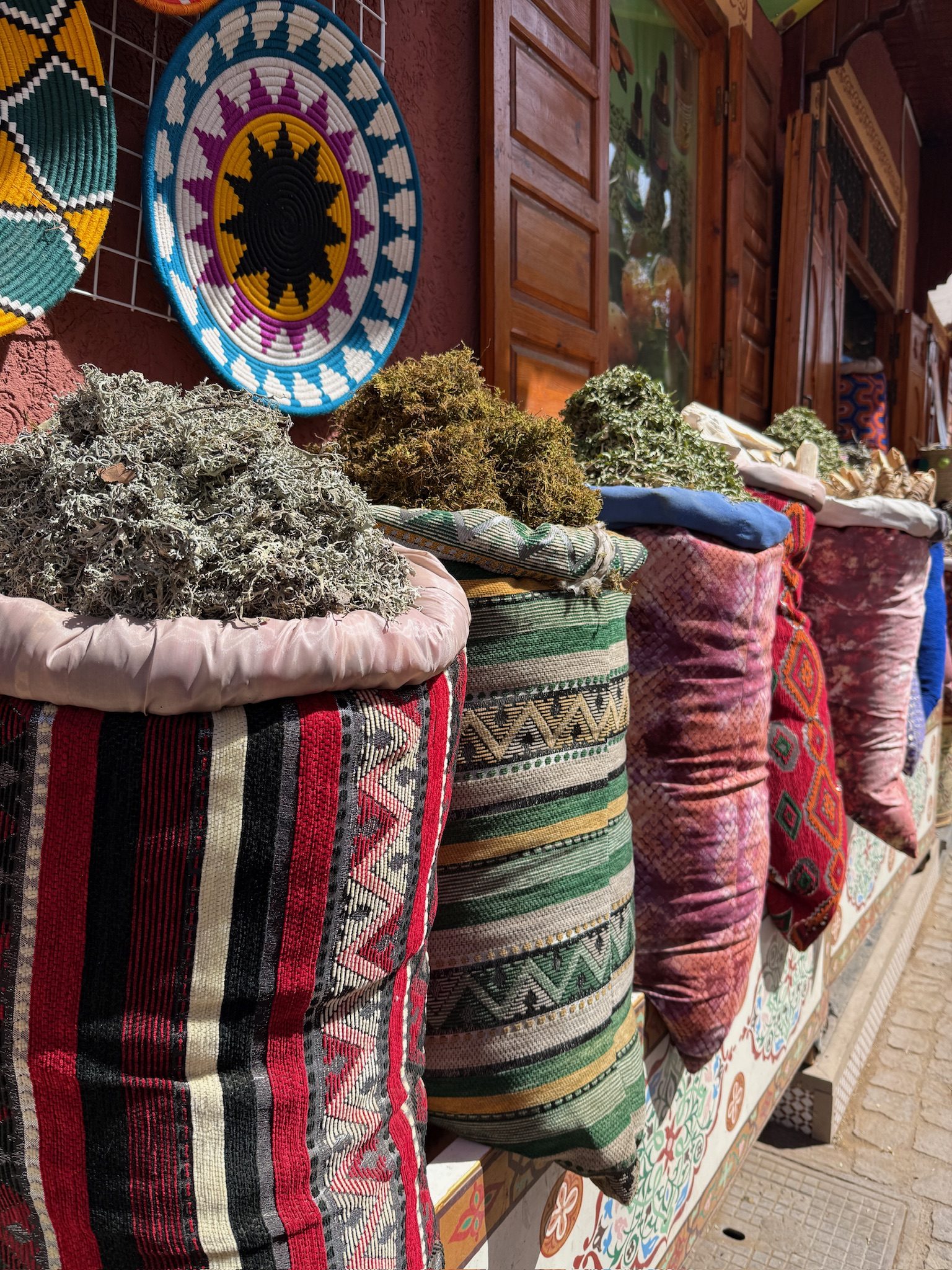 Woven sacks of dried herbs and spices at a Berber pharmacy in Marrakesh