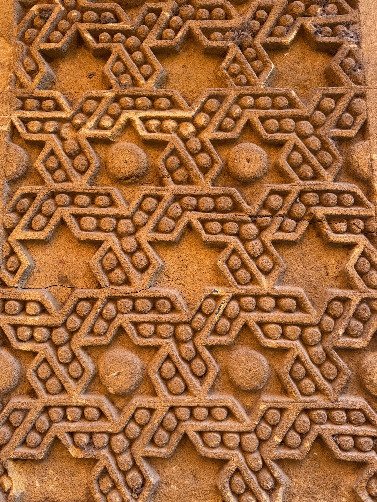 Close-up of a carved geometric pattern on a wall in Marrakesh