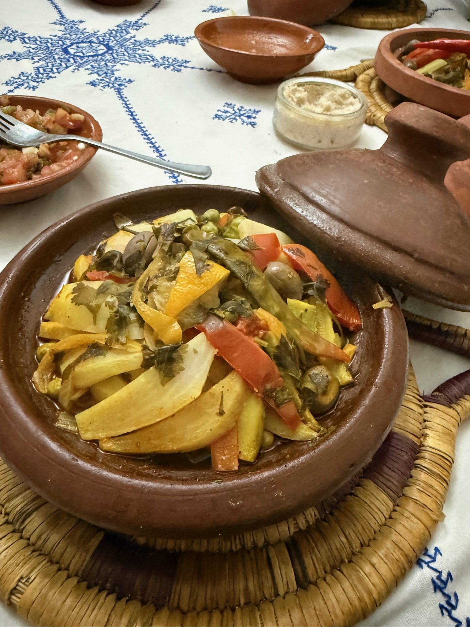 Vegetable tagine with potatoes, carrots, and olives in a clay pot