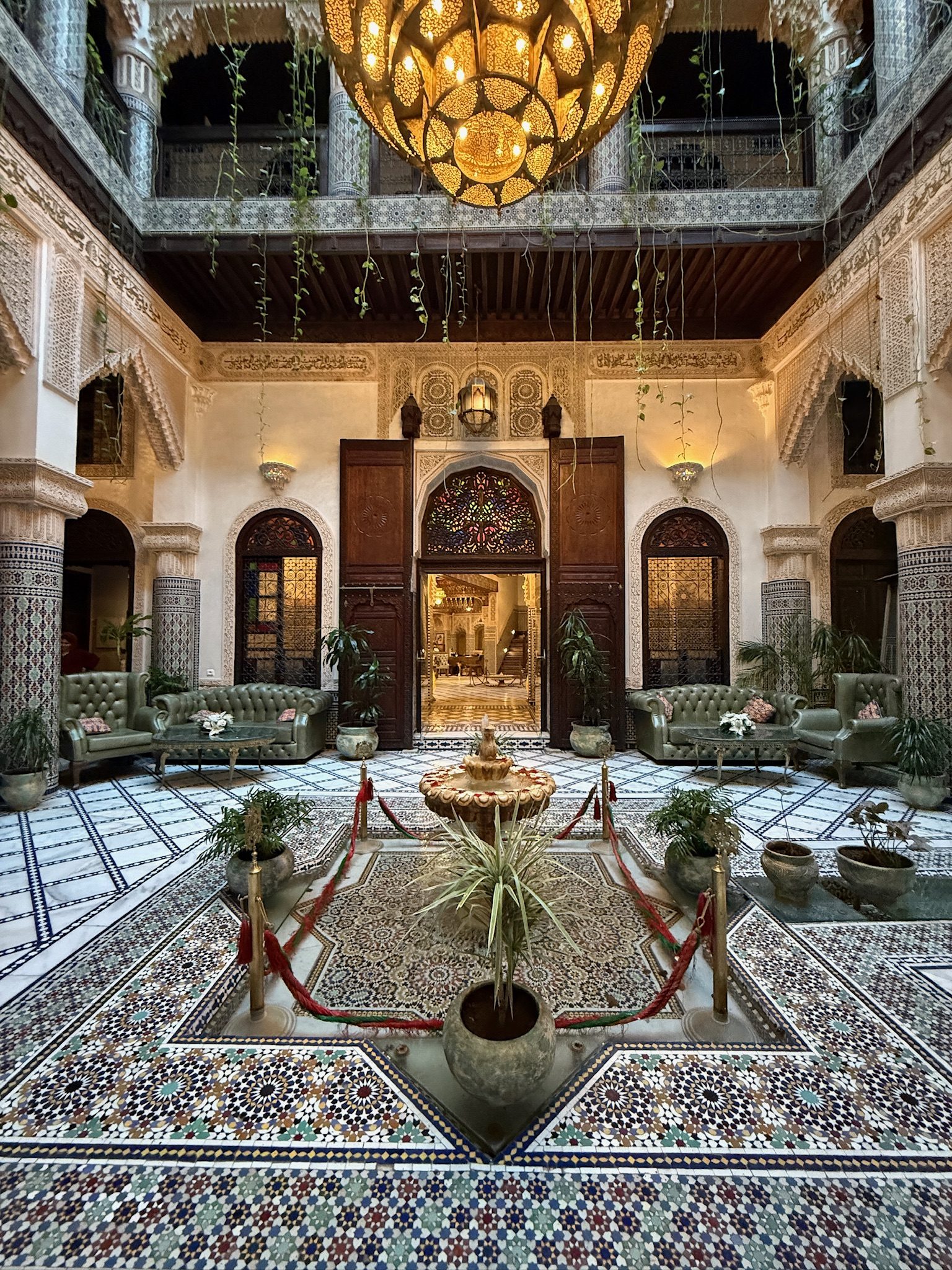 Ornate courtyard with a fountain and hanging lantern at Riad Salam Fes