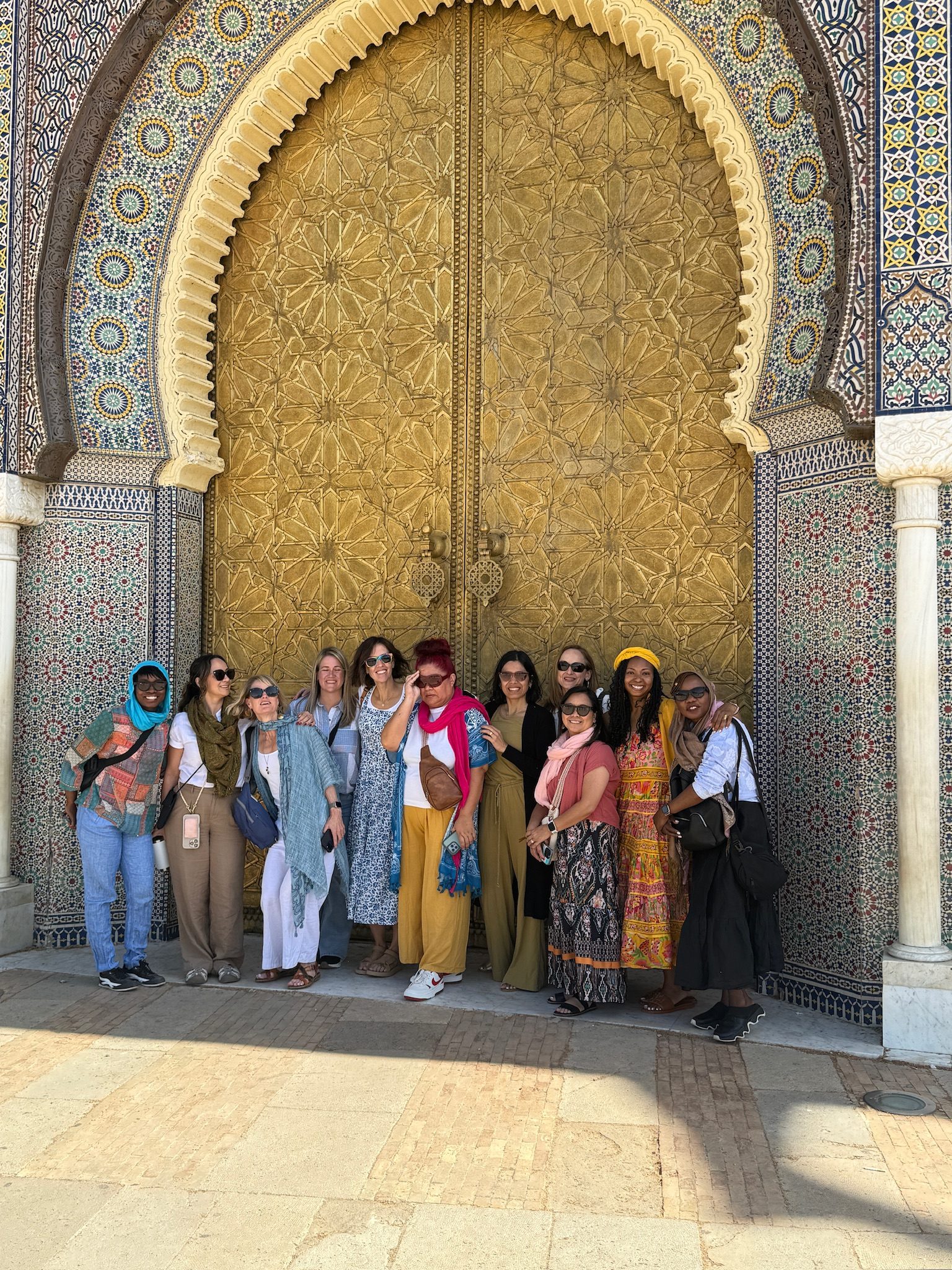 Group of women in front of the golden doors of the Royal Palace in Fes