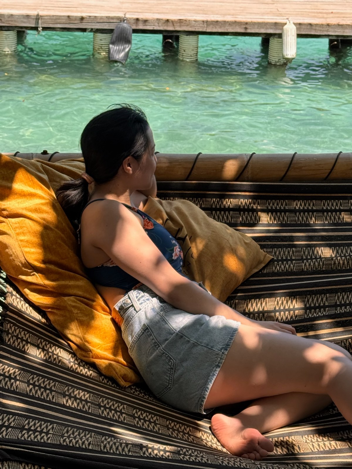 Relaxing on a shaded daybed over the turquoise water in the Rosario Islands