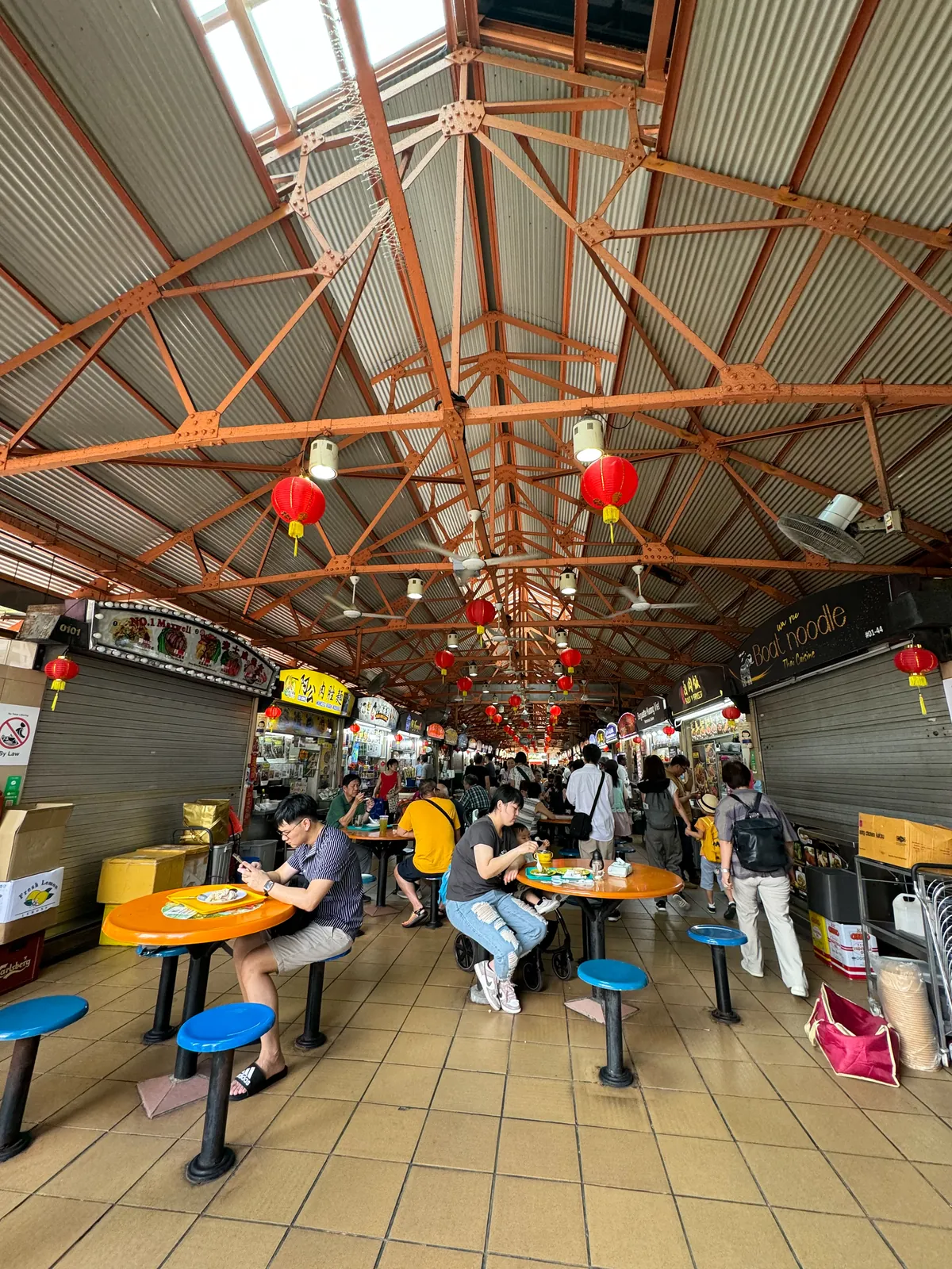Lunchtime crowd eating at Maxwell Food Centre hawker center in Singapore